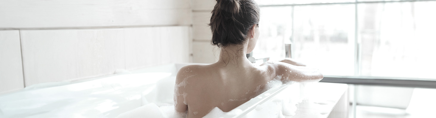 Mujer de espaldas tomando un baño de tina